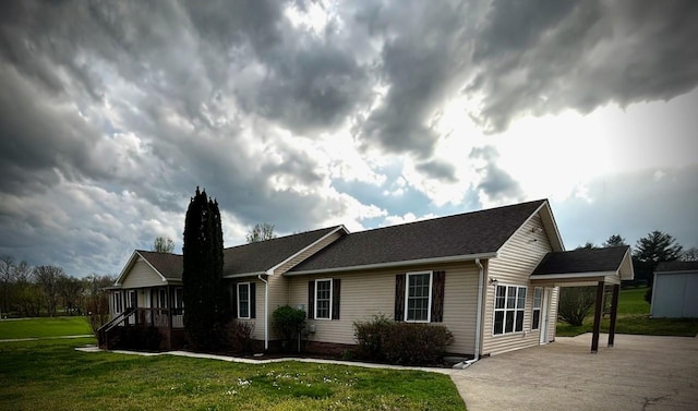 exterior space with a lawn and concrete driveway