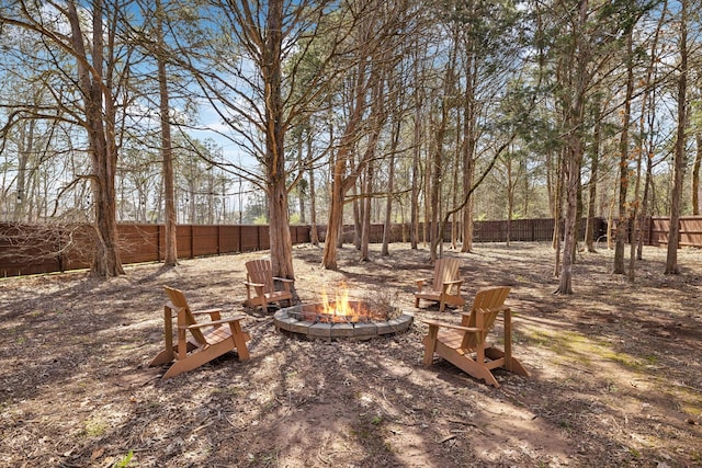 view of yard with a fenced backyard and an outdoor fire pit