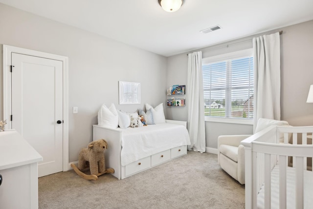 bedroom with visible vents and carpet