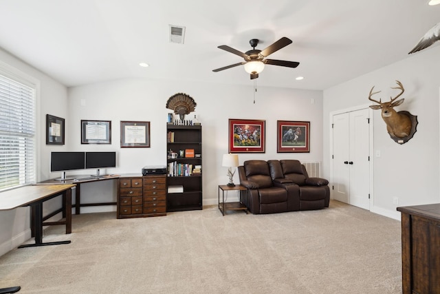 office area with light colored carpet, visible vents, baseboards, and a ceiling fan