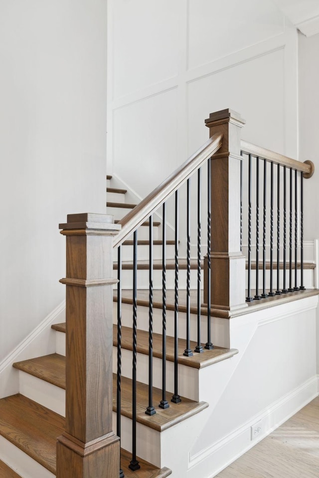 stairway featuring wood finished floors