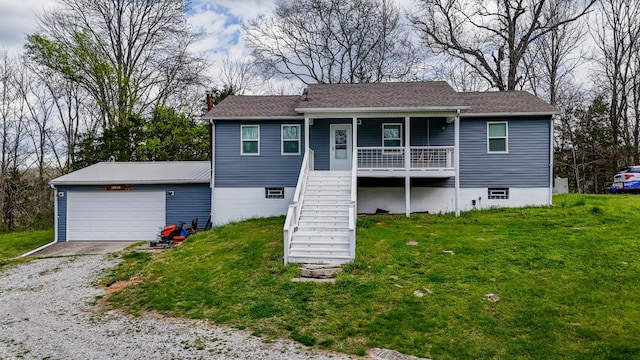 view of front of property with a front yard, covered porch, a garage, stairs, and driveway
