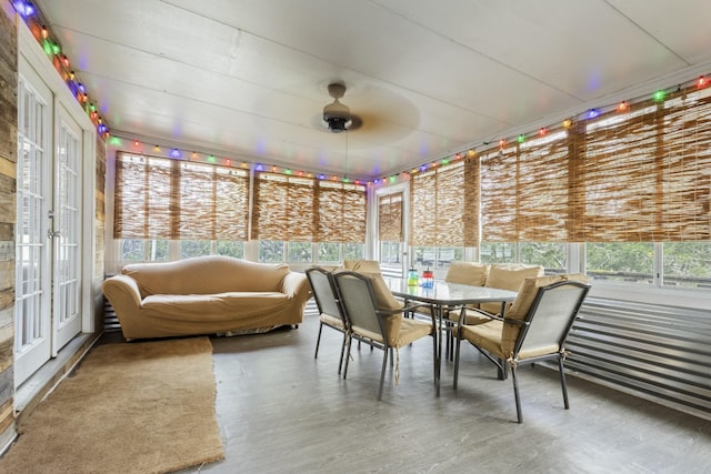 sunroom featuring french doors, outdoor dining space, a ceiling fan, and plenty of natural light