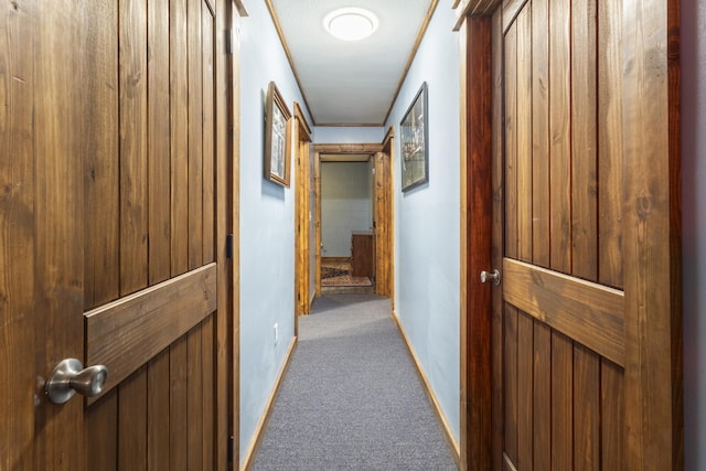corridor with carpet flooring and baseboards