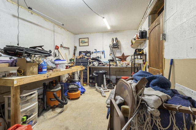 interior space featuring a workshop area and concrete block wall