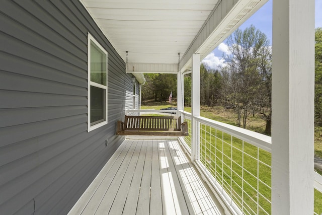 wooden terrace featuring covered porch