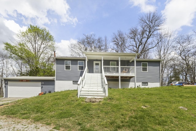 view of front of property featuring a garage, stairs, a porch, and a front lawn