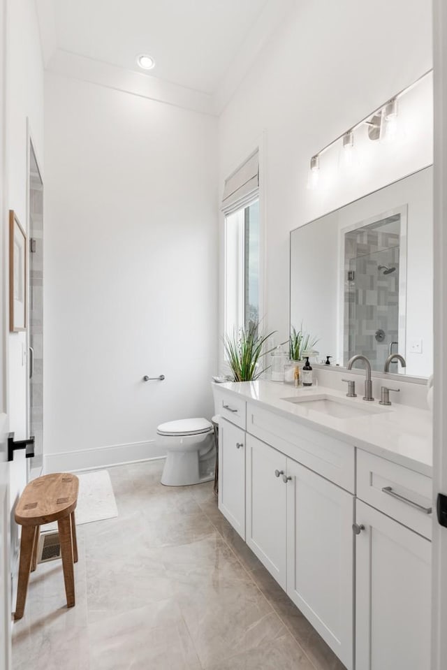 full bath featuring a stall shower, crown molding, toilet, vanity, and baseboards