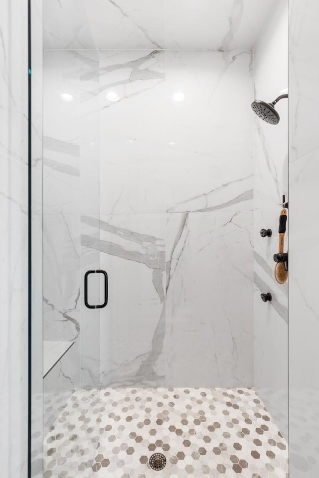 bathroom with a marble finish shower