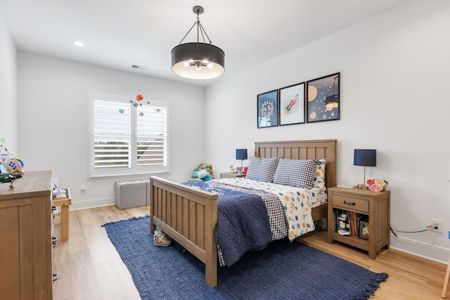 bedroom featuring baseboards, visible vents, and light wood-type flooring