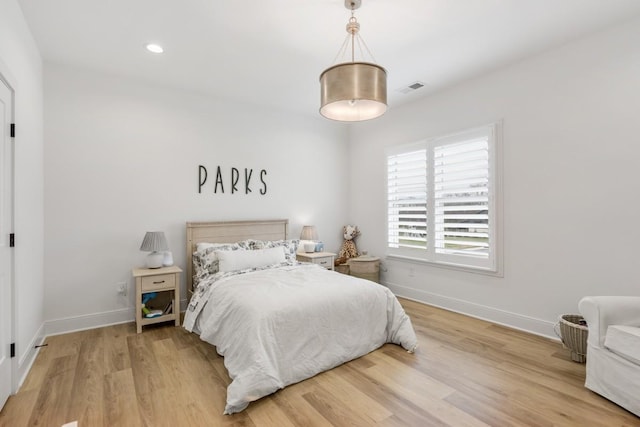 bedroom featuring baseboards, visible vents, recessed lighting, and wood finished floors
