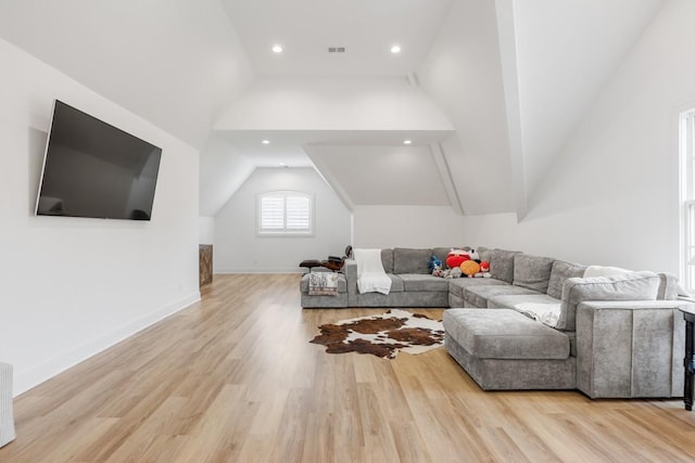 living room featuring baseboards, lofted ceiling, wood finished floors, and recessed lighting