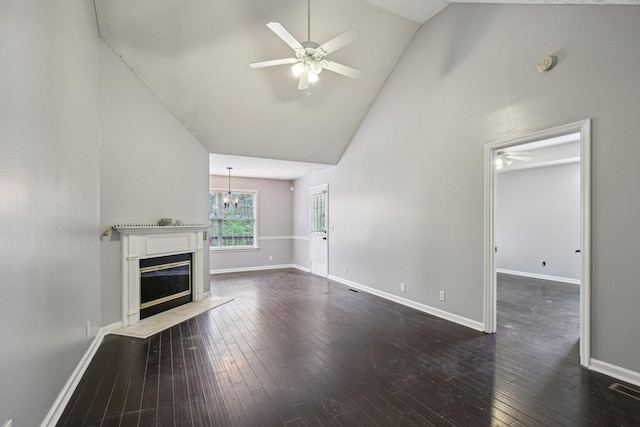 unfurnished living room featuring dark wood-type flooring, baseboards, a glass covered fireplace, and ceiling fan with notable chandelier