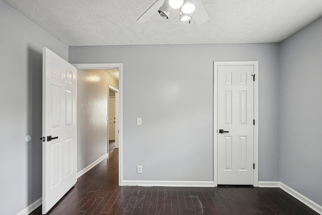 unfurnished bedroom featuring baseboards, wood finished floors, ceiling fan, and a textured ceiling