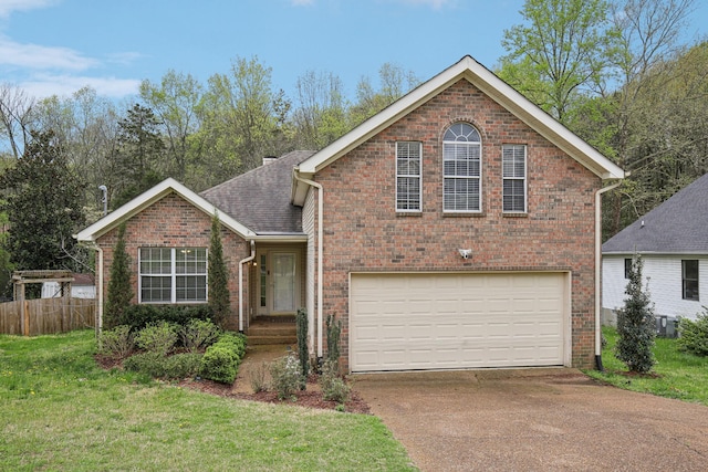 view of front of house with brick siding, concrete driveway, a garage, and a front lawn