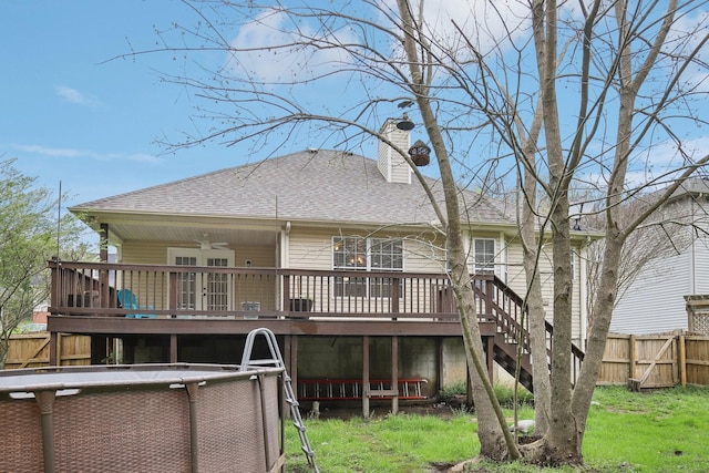 rear view of property with stairway, fence, a deck, ceiling fan, and a shingled roof