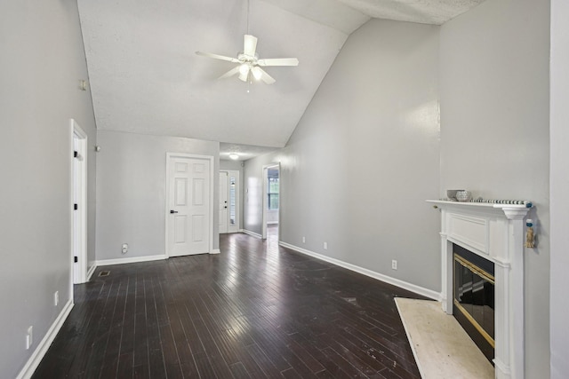 unfurnished living room with high vaulted ceiling, baseboards, wood finished floors, a ceiling fan, and a glass covered fireplace