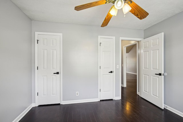 unfurnished bedroom featuring a ceiling fan, a textured ceiling, baseboards, and wood finished floors