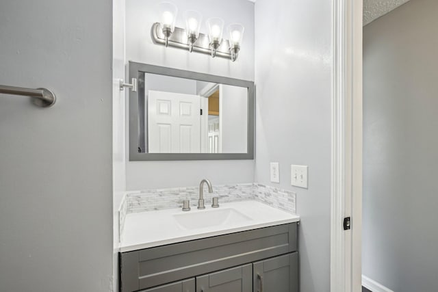 bathroom featuring decorative backsplash and vanity