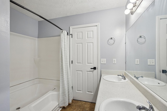 full bath with shower / bath combination with curtain, a sink, and a textured ceiling