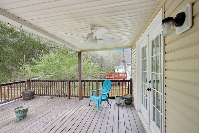 wooden deck featuring french doors and a ceiling fan