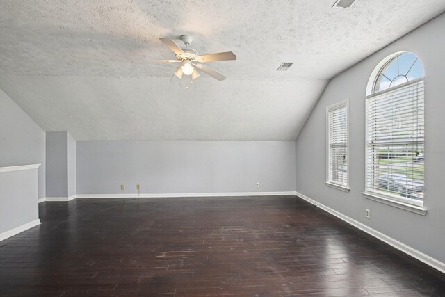 bonus room with hardwood / wood-style floors, baseboards, ceiling fan, and visible vents