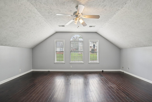 bonus room with baseboards, visible vents, wood finished floors, and a textured ceiling