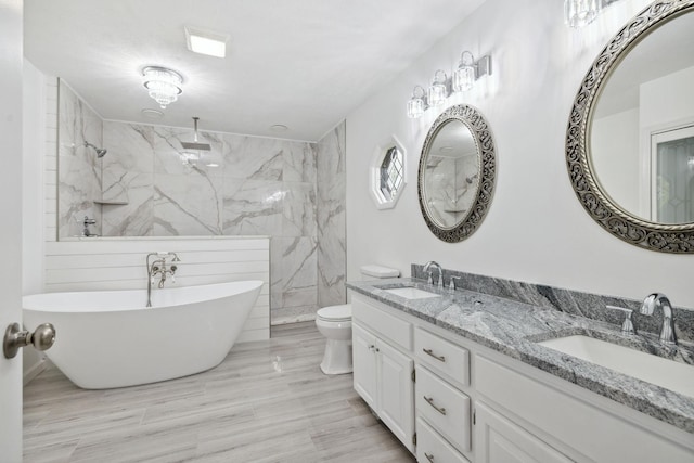 full bathroom with double vanity, a sink, toilet, and walk in shower