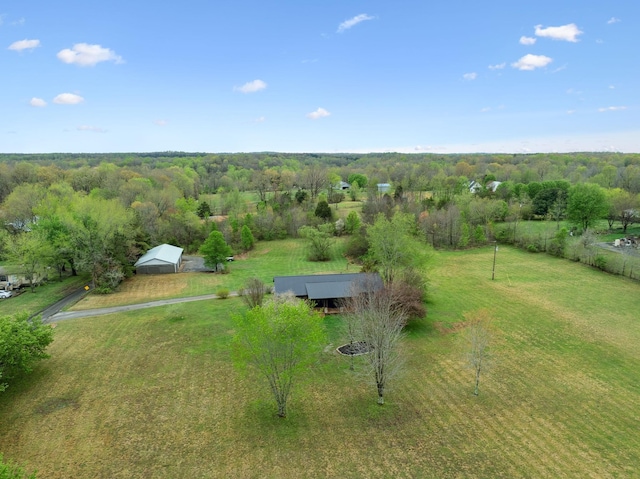 bird's eye view featuring a wooded view and a rural view