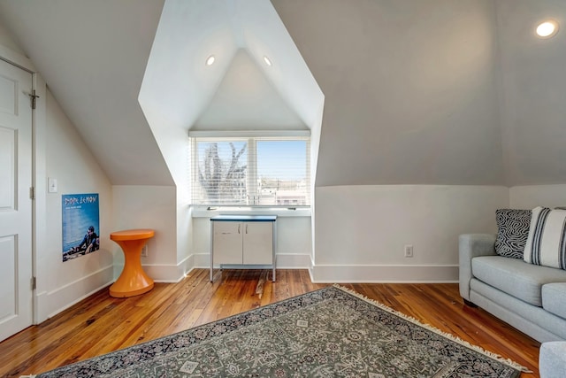 sitting room with baseboards, lofted ceiling, light wood finished floors, and recessed lighting