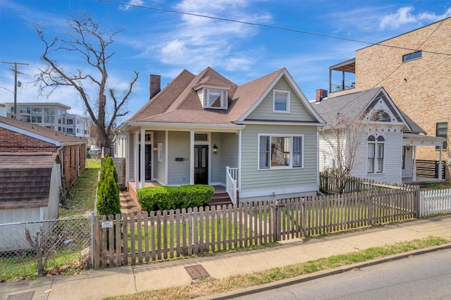 view of front of house with a fenced front yard and a chimney