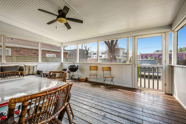 sunroom / solarium featuring ceiling fan