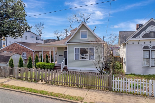 view of front of house with a front yard and a fenced front yard