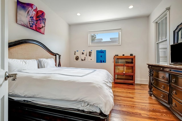 bedroom with baseboards, light wood-type flooring, and recessed lighting