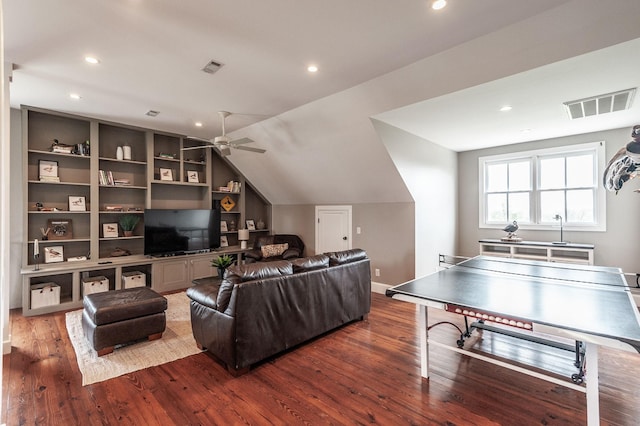 living area featuring lofted ceiling, ceiling fan, visible vents, and wood finished floors