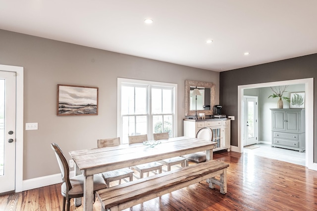dining area featuring light wood-style flooring, baseboards, and recessed lighting