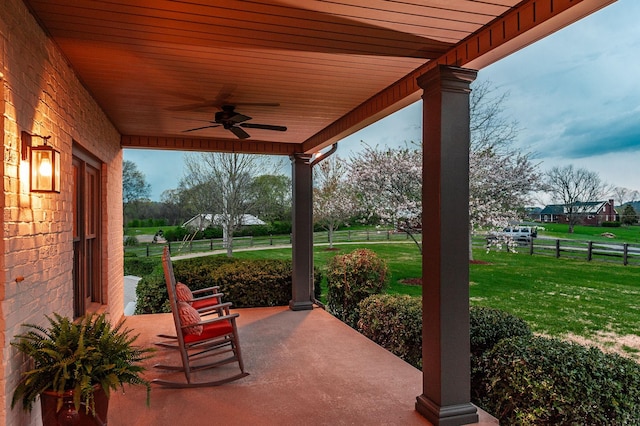 view of patio / terrace with fence and a ceiling fan