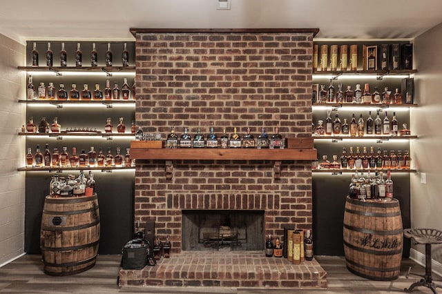 interior space featuring wood finished floors and a brick fireplace