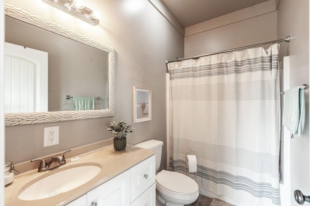 bathroom featuring a shower with shower curtain, toilet, and vanity