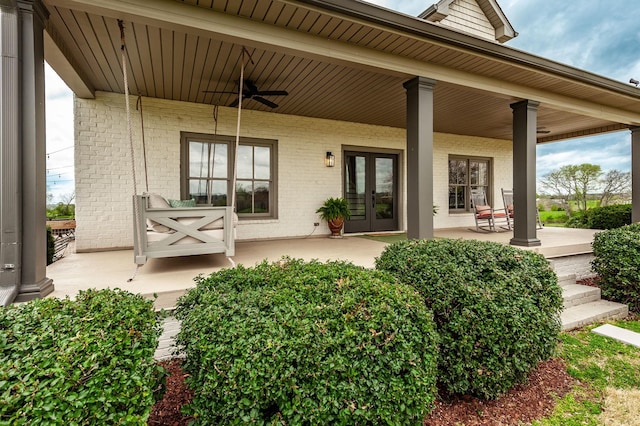 view of patio featuring ceiling fan, french doors, and a porch