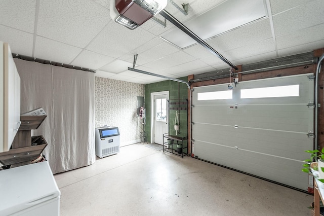 garage with wallpapered walls and a garage door opener