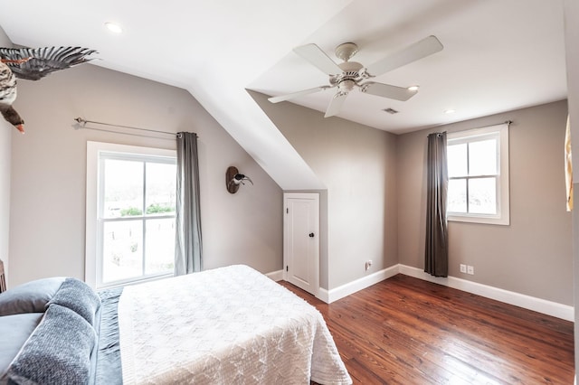 bedroom featuring visible vents, baseboards, ceiling fan, dark wood-type flooring, and lofted ceiling