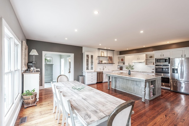 dining area with recessed lighting, dark wood-type flooring, and visible vents