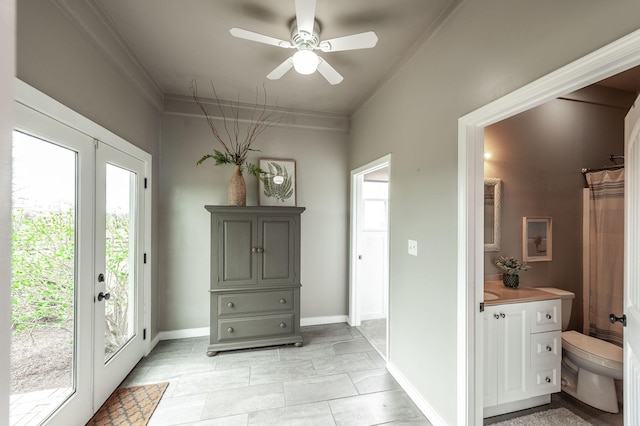 interior space with ornamental molding, baseboards, and ceiling fan