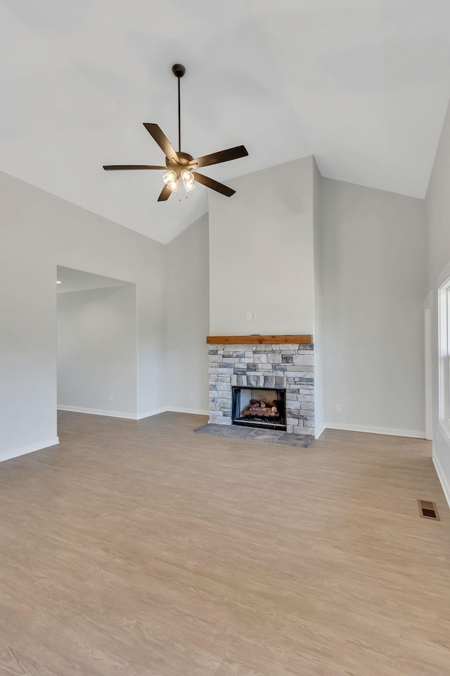 198 Creekside Dr, Lewisburg, TN 37091 - unfurnished living room with baseboards, light wood finished floors, visible vents, a ceiling fan, and a stone fireplace