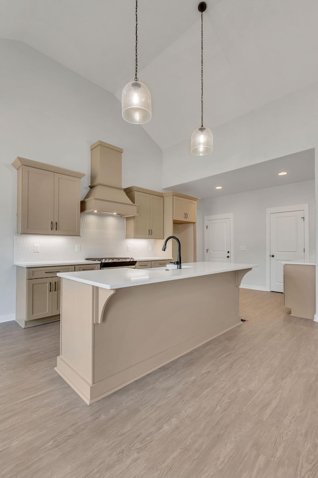 198 Creekside Dr, Lewisburg, TN 37091 - kitchen featuring light countertops, light wood finished floors, high vaulted ceiling, and custom exhaust hood