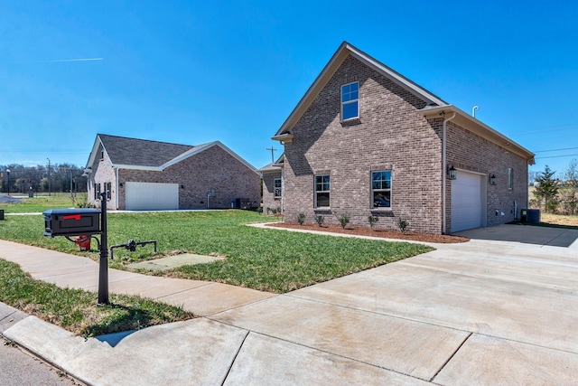 200 Creekside Dr, Lewisburg, TN 37091 - view of side of property with brick siding, driveway, a yard, and an attached garage