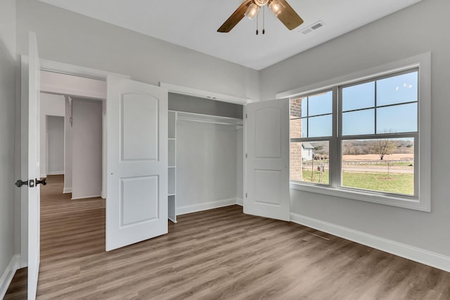200 Creekside Dr, Lewisburg, TN 37091 - unfurnished bedroom featuring baseboards, visible vents, a closet, and wood finished floors