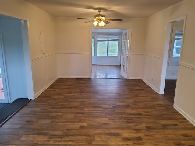 1833 Porterfield Rd, Readyville, TN 37149 - spare room with wainscoting, dark wood-style flooring, crown molding, and ceiling fan
