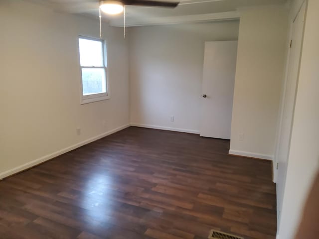 1833 Porterfield Rd, Readyville, TN 37149 - spare room with visible vents, baseboards, ceiling fan, and dark wood finished floors